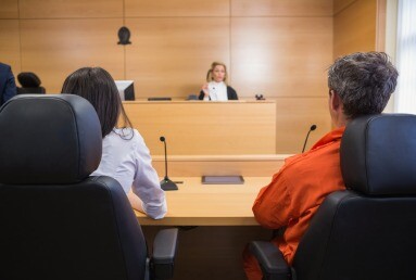 Lawyer and client listening to judge in the court room